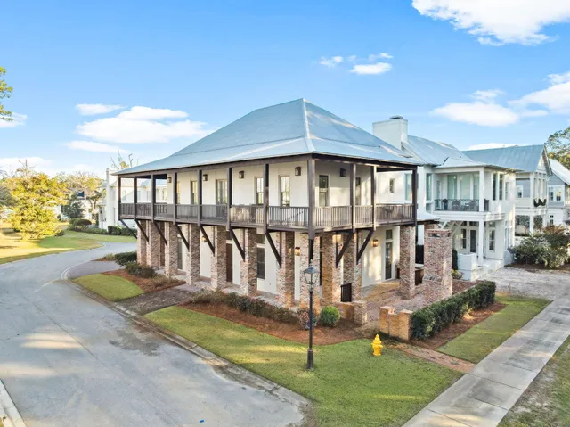 a living room with furniture floor to ceiling window and wooden floor