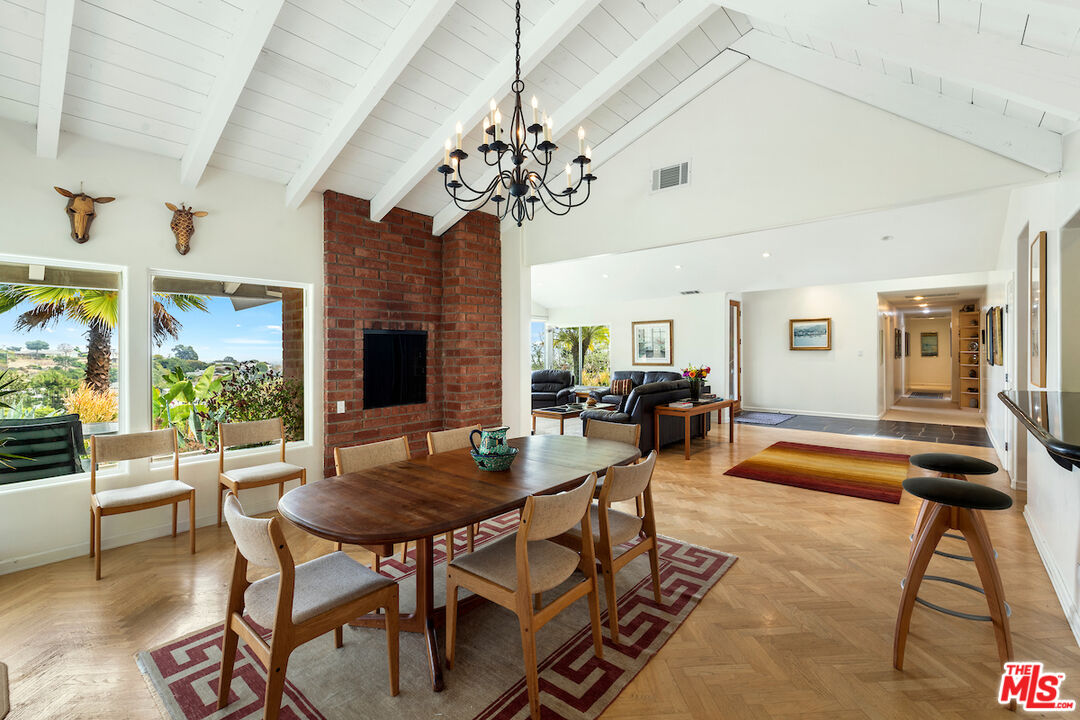 1336 Las Canoas Road Pacific Palisades, CA 90272 - Photo 11 of 37 a living room with fireplace furniture and a chandelier