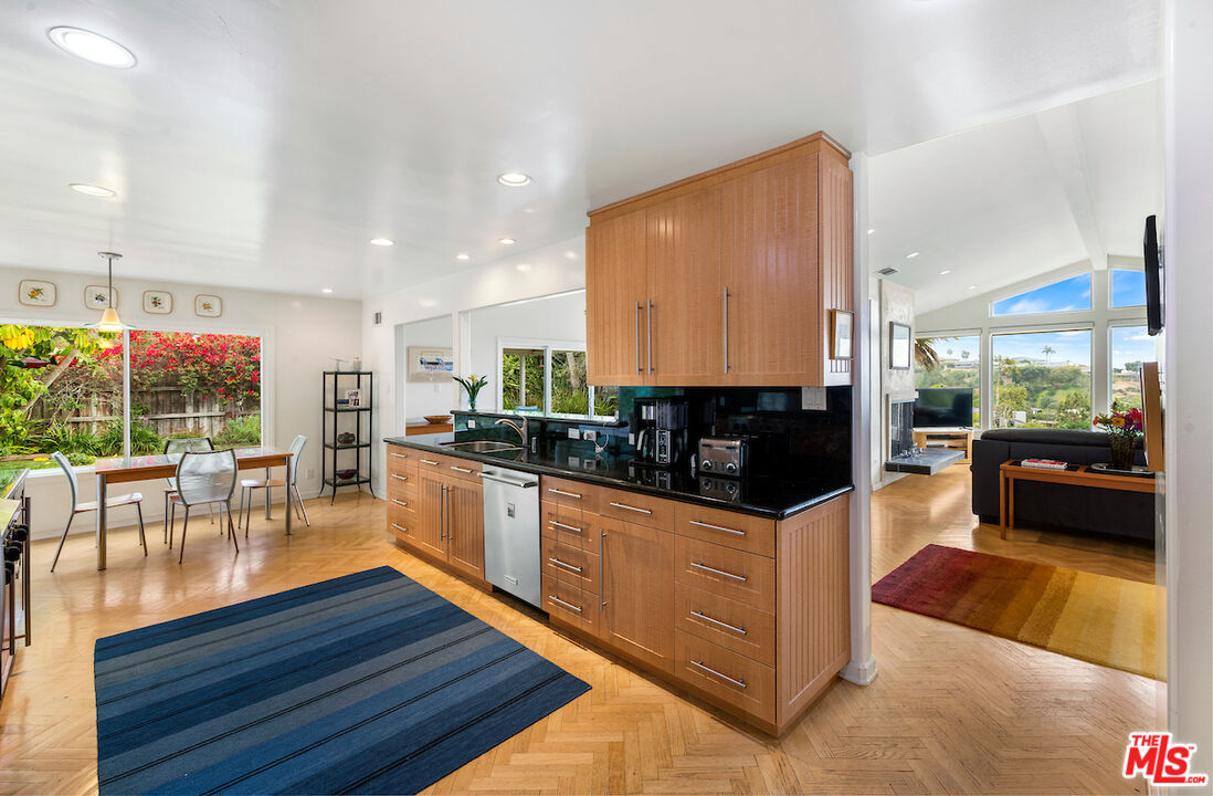1336 Las Canoas Road Pacific Palisades, CA 90272 - Photo 15 of 37 a kitchen with wooden cabinets and counter space