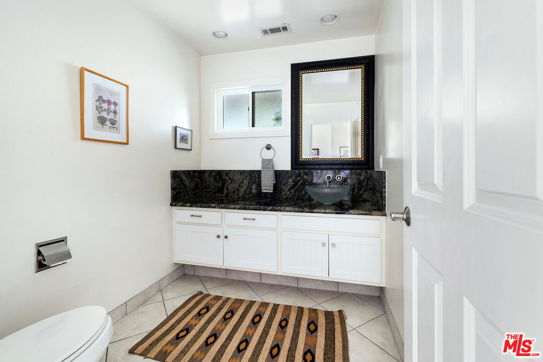 1336 Las Canoas Road Pacific Palisades, CA 90272 - Photo 19 of 37 a bathroom with a sink and a mirror