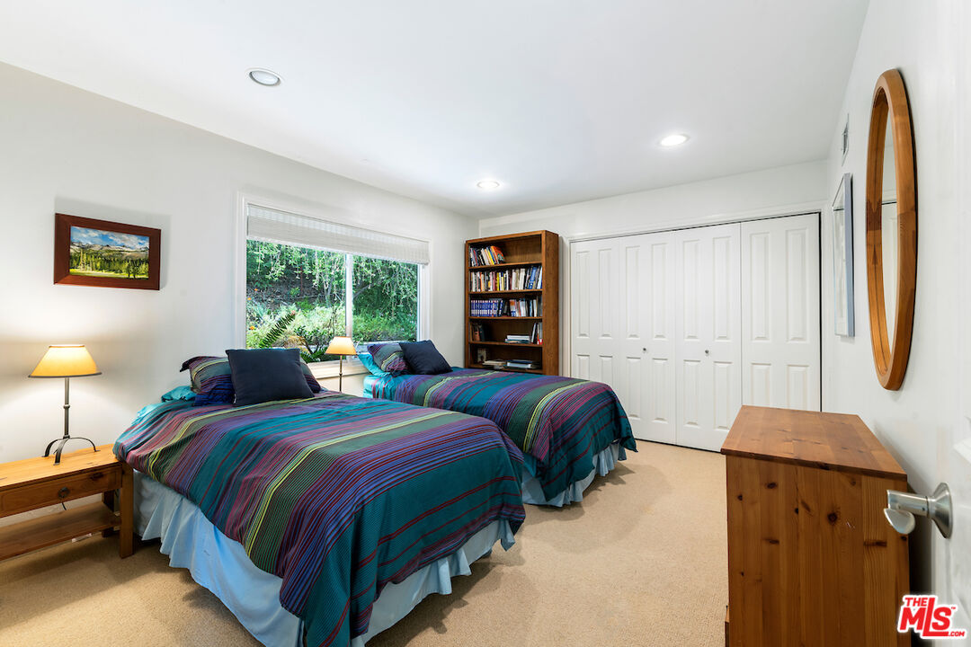 1336 Las Canoas Road Pacific Palisades, CA 90272 - Photo 23 of 37 a bedroom with bed and window