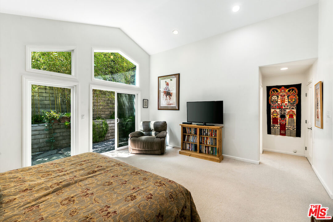 1336 Las Canoas Road Pacific Palisades, CA 90272 - Photo 26 of 37 a bedroom with furniture window and flat screen tv