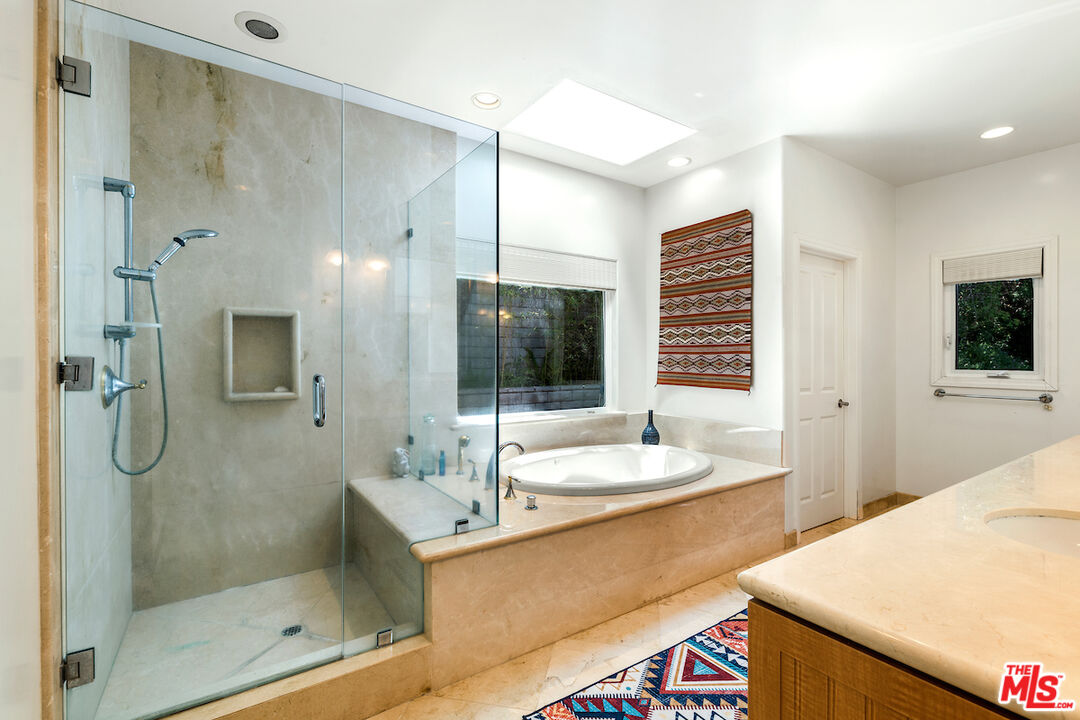 1336 Las Canoas Road Pacific Palisades, CA 90272 - Photo 27 of 37 a bathroom with a granite countertop sink mirror and shower