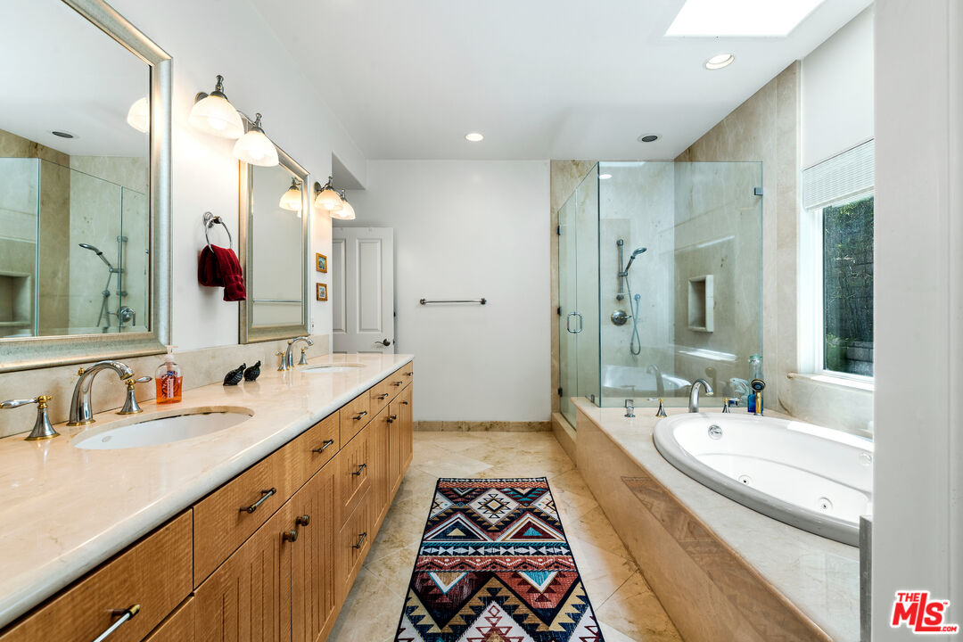 1336 Las Canoas Road Pacific Palisades, CA 90272 - Photo 28 of 37 a spacious bathroom with a double vanity sink mirror double and shower