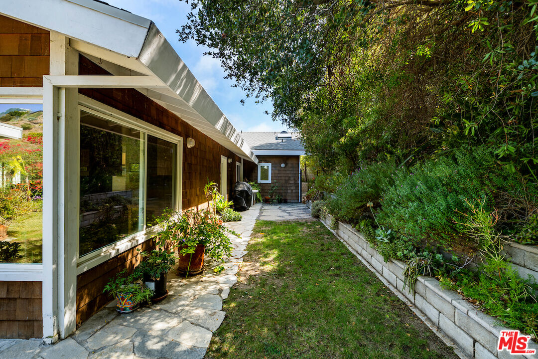 1336 Las Canoas Road Pacific Palisades, CA 90272 - Photo 33 of 37 a view of a house with backyard and porch