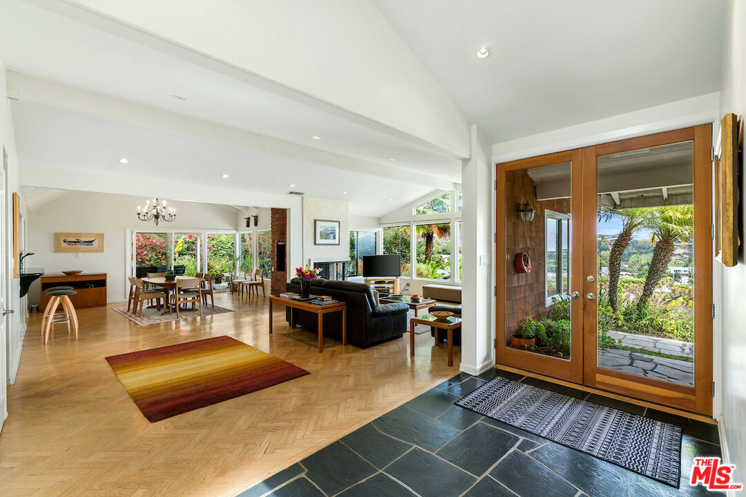 1336 Las Canoas Road Pacific Palisades, CA 90272 - Photo 5 of 37 a living room with furniture and a wooden floor