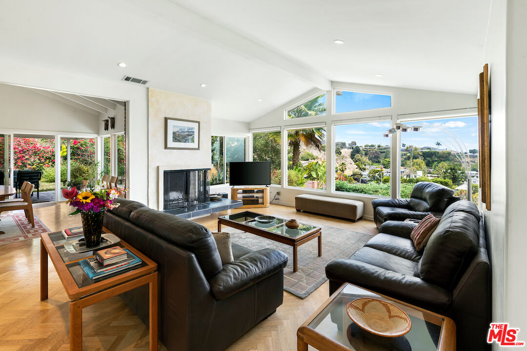 1336 Las Canoas Road Pacific Palisades, CA 90272 - Photo 9 of 37 a living room with furniture and a large window