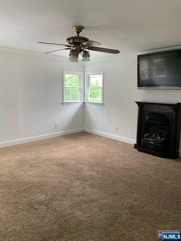 73 East Gouverneur Avenue Rutherford, NJ 07070 - Photo 14 of 33 an empty room with a fireplace and windows