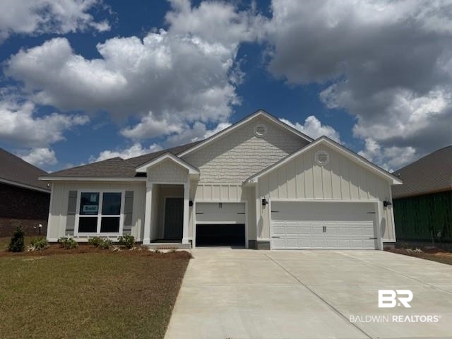 267 Tillage Street Fairhope, AL 36532 - Photo 1 of 18 View of front facade with a garage, board and batten siding, driveway, and a front yard