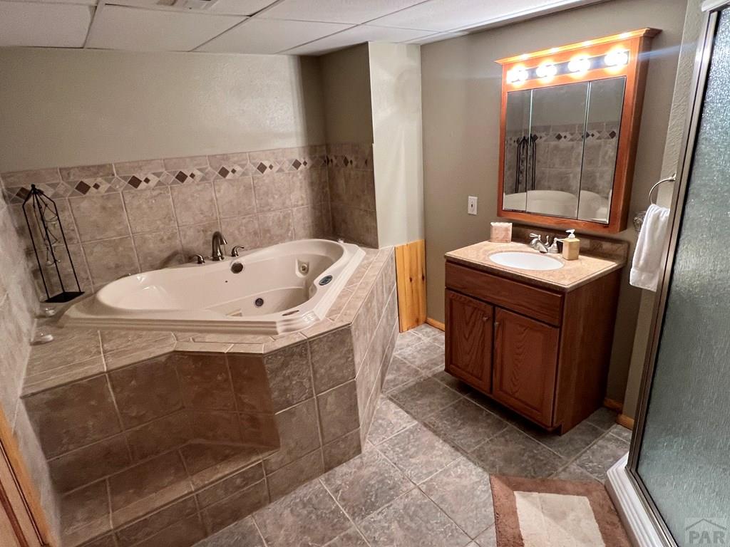 105 St Charles Avenue Rye, CO 81069 - Photo 18 of 35 a bathroom with a sink a mirror and a bathtub