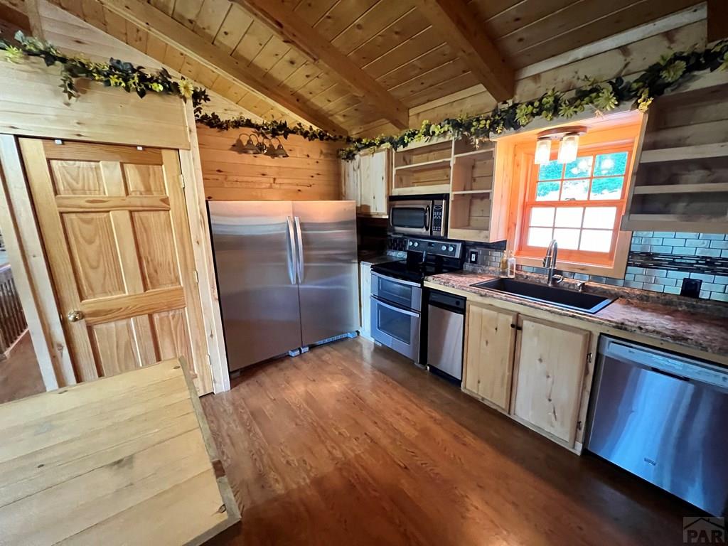 105 St Charles Avenue Rye, CO 81069 - Photo 4 of 35 a kitchen with stainless steel appliances granite countertop a refrigerator and wooden cabinets