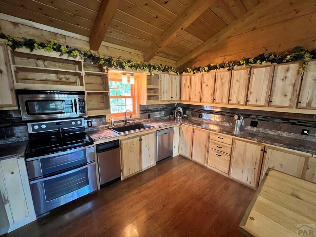 105 St Charles Avenue Rye, CO 81069 - Photo 5 of 35 a kitchen with granite countertop a sink cabinets stainless steel appliances and a counter top