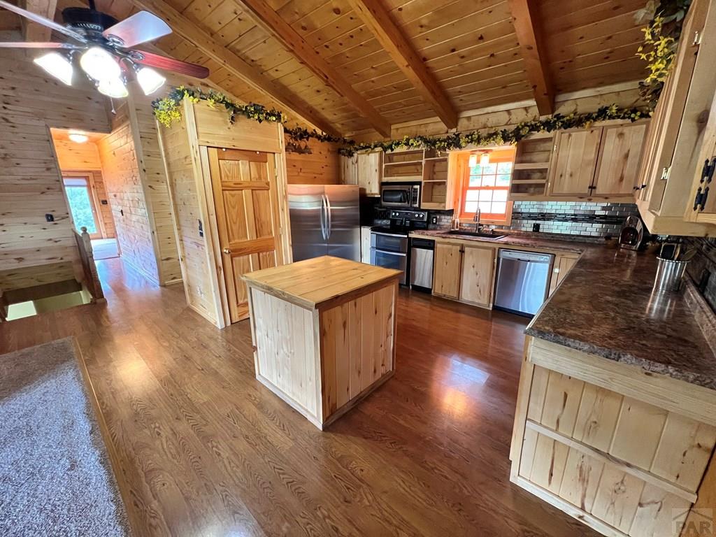 105 St Charles Avenue Rye, CO 81069 - Photo 6 of 35 a kitchen with stove and wooden floor