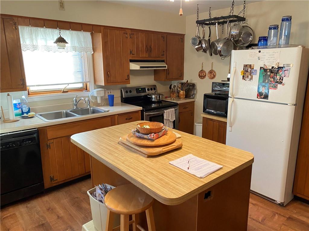 595 Golf Course Road Aliquippa, PA 15001 - Photo 12 of 21 a kitchen with a refrigerator a stove a sink and a dining table