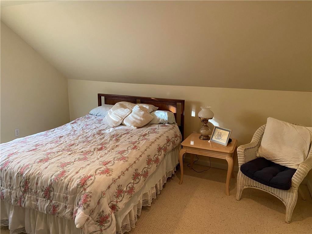 595 Golf Course Road Aliquippa, PA 15001 - Photo 17 of 21 a bed sitting in a bedroom next to a lamp