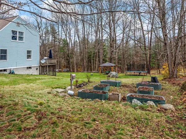 a backyard of a house with table and chairs