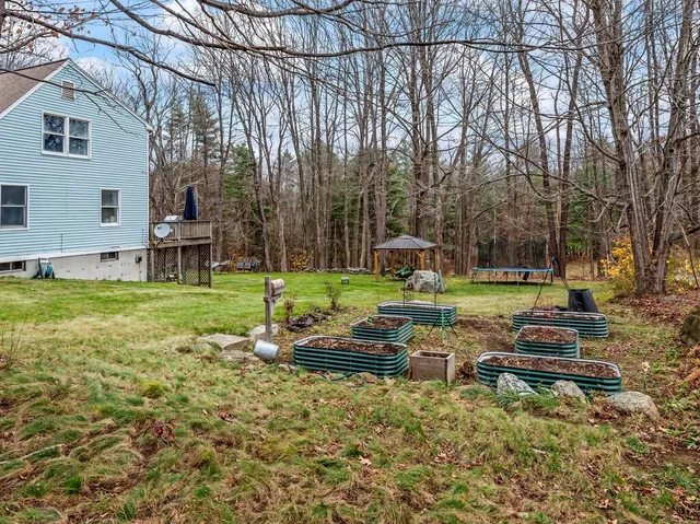 a backyard of a house with table and chairs