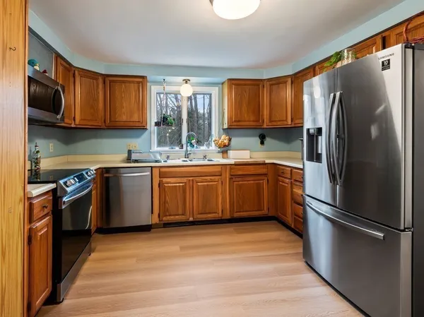 a kitchen with stainless steel appliances granite countertop a stove sink and cabinets