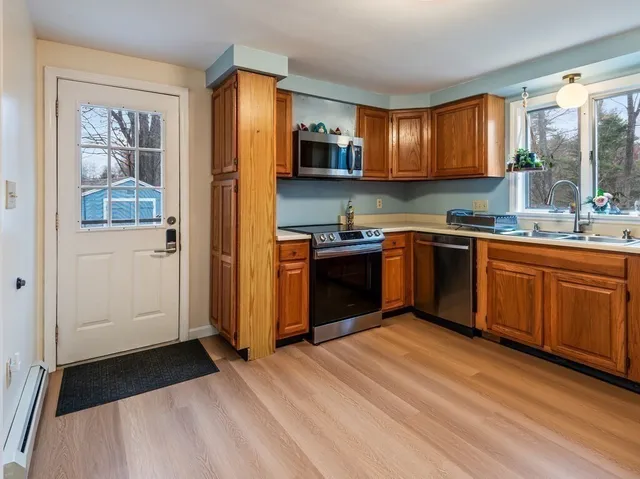 a kitchen with stainless steel appliances granite countertop a stove and a refrigerator