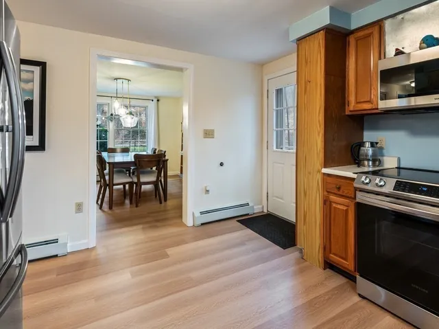 a kitchen with stainless steel appliances granite countertop a refrigerator and a stove top oven