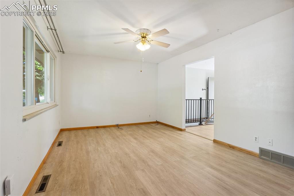 3709 Anemone Circle Colorado Springs, CO 80918 - Photo 12 of 32 wooden floor in an empty room with a window