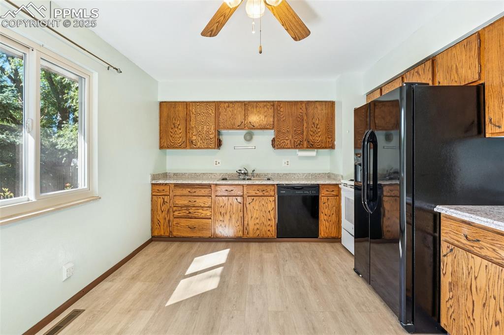 3709 Anemone Circle Colorado Springs, CO 80918 - Photo 17 of 32 a kitchen with stainless steel appliances a refrigerator and a stove