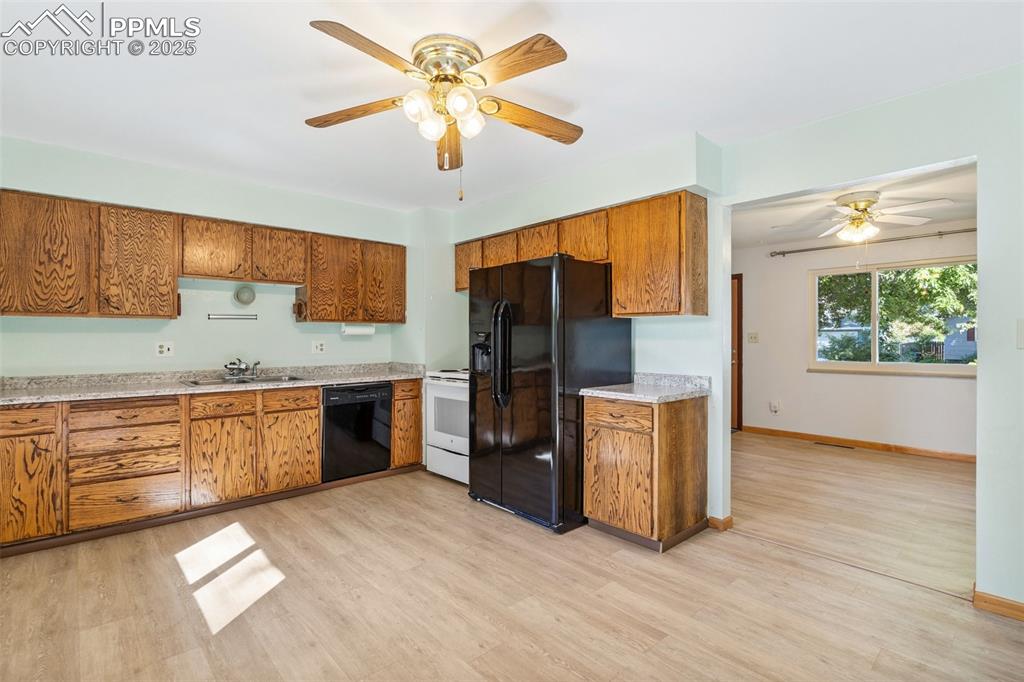 3709 Anemone Circle Colorado Springs, CO 80918 - Photo 18 of 32 a kitchen with granite countertop stainless steel appliances a stove cabinets and wooden floor