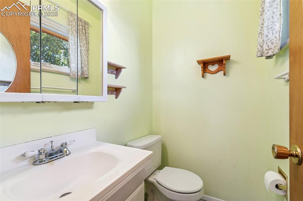 3709 Anemone Circle Colorado Springs, CO 80918 - Photo 21 of 32 a bathroom with a sink mirror and toilet