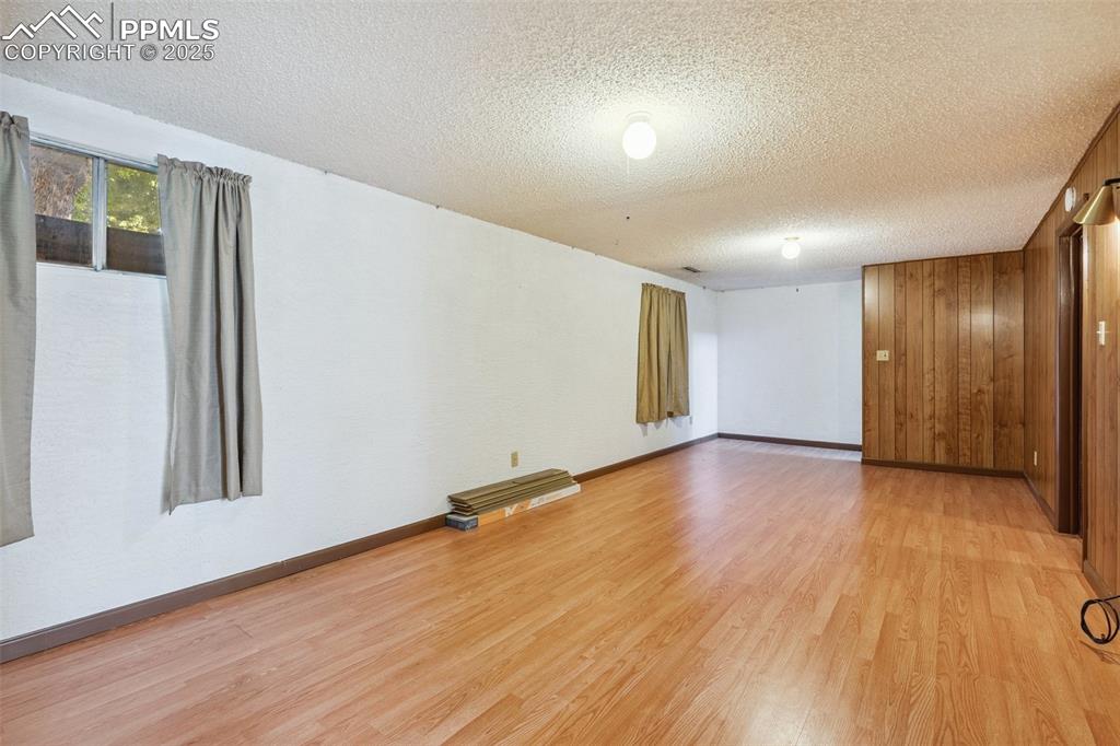 3709 Anemone Circle Colorado Springs, CO 80918 - Photo 26 of 32 an empty room with wooden floor and windows