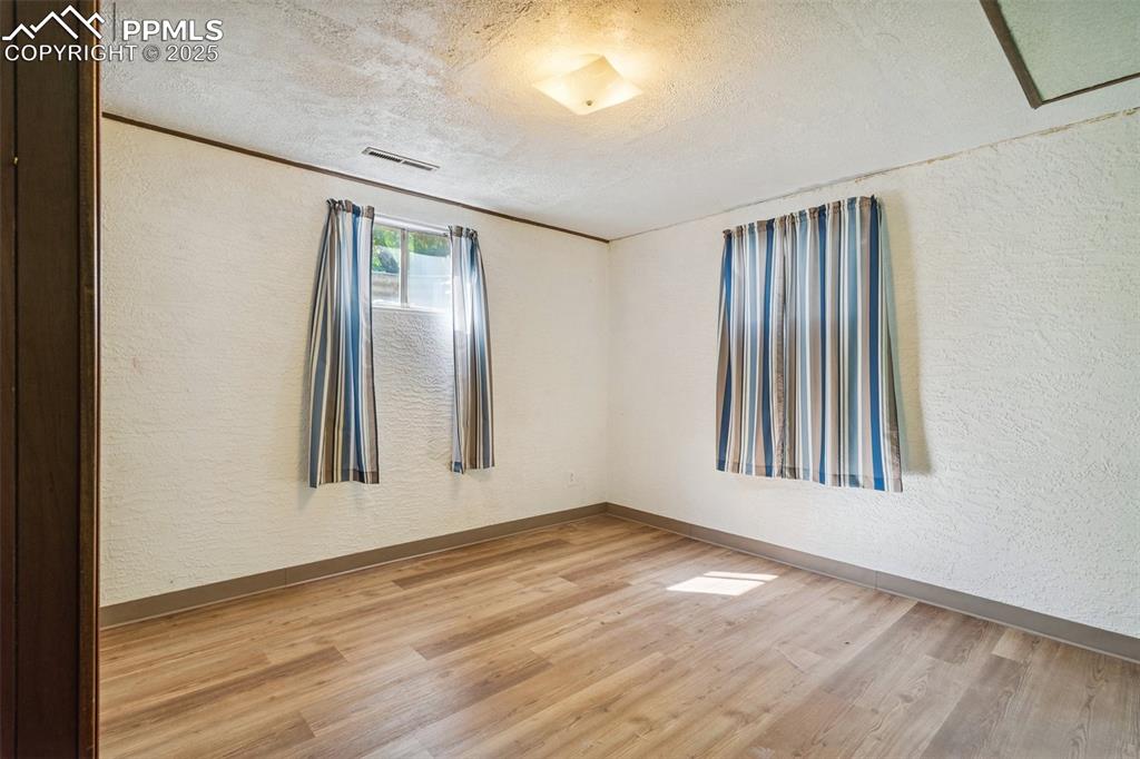 3709 Anemone Circle Colorado Springs, CO 80918 - Photo 29 of 32 an empty room with wooden floor and a window