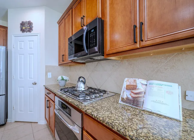 a kitchen with wooden cabinets and a stove top oven