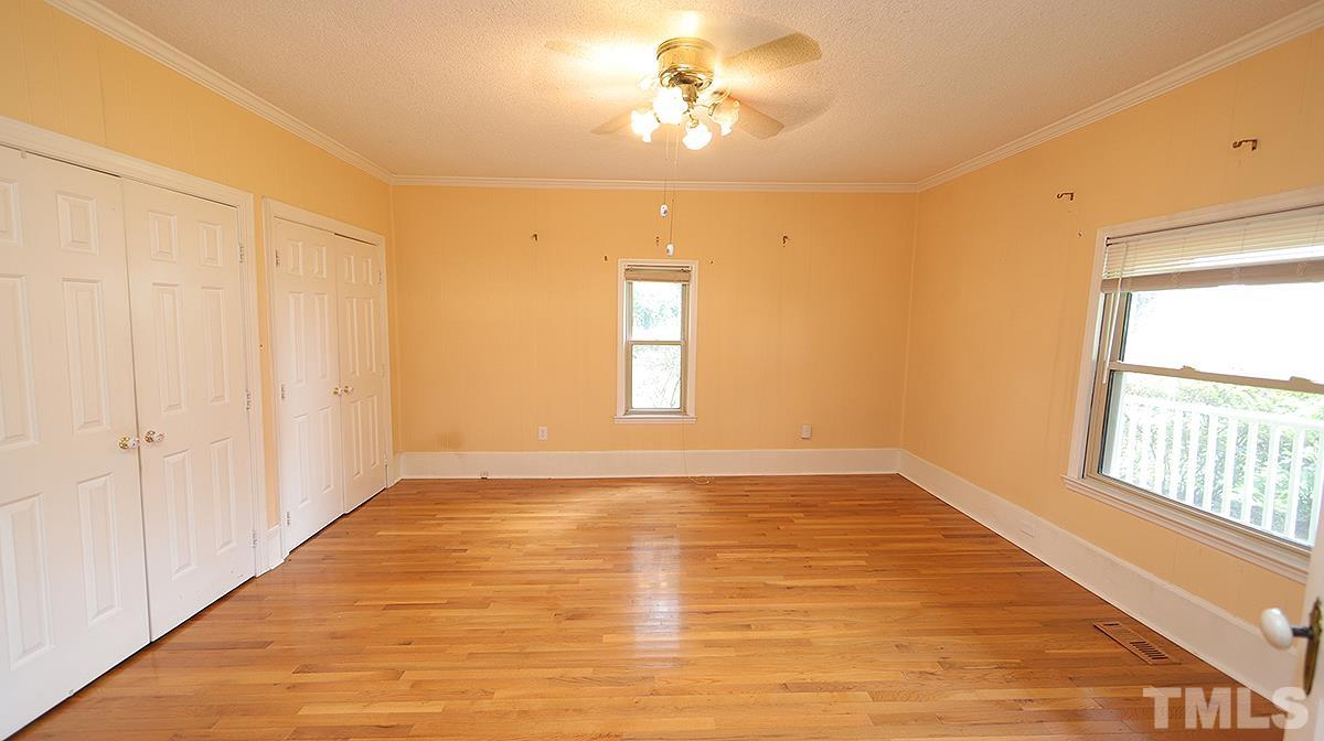 1390 Sanders Road Benson, NC 27504 - Photo 11 of 22 a view of an empty room with window and wooden floor