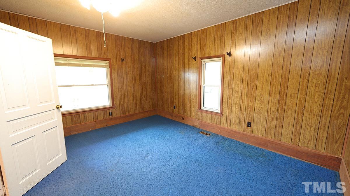 1390 Sanders Road Benson, NC 27504 - Photo 13 of 22 a view of an empty room with a window