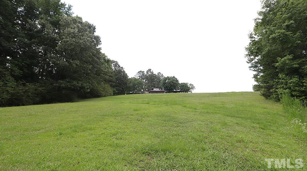 1390 Sanders Road Benson, NC 27504 - Photo 16 of 22 a view of grassy field with trees