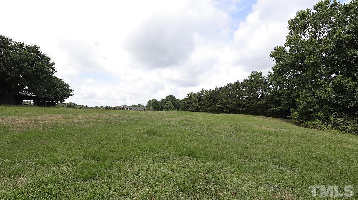 1390 Sanders Road Benson, NC 27504 - Photo 17 of 22 a view of a field with an trees