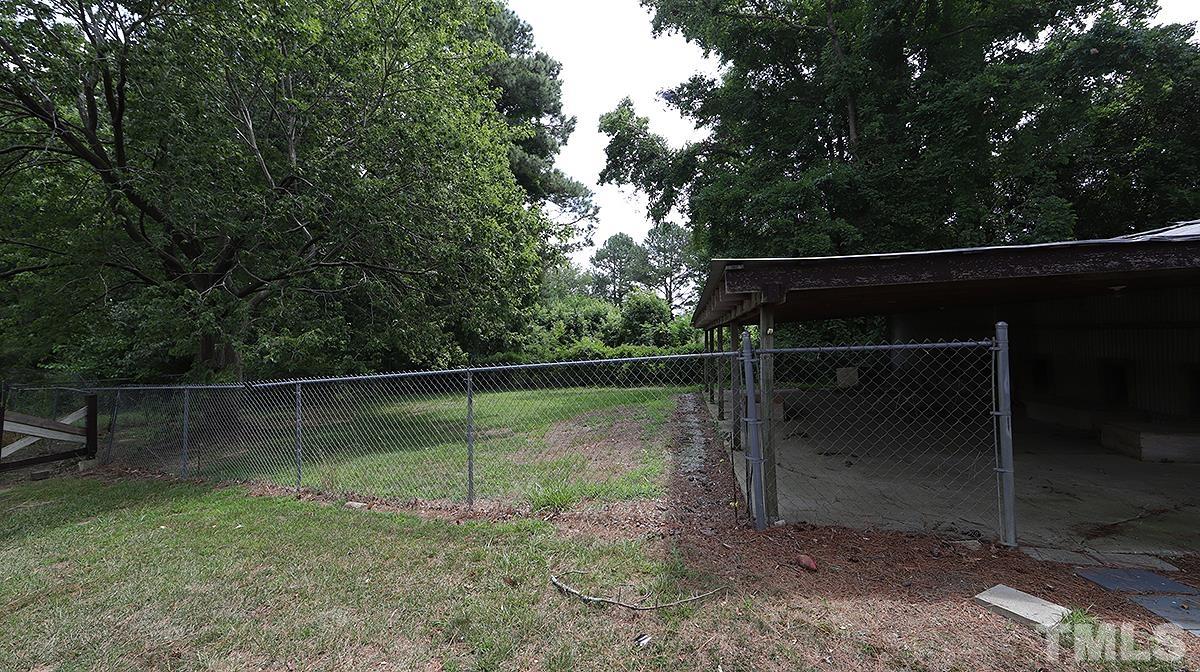 1390 Sanders Road Benson, NC 27504 - Photo 19 of 22 a backyard of a house with lots of green space
