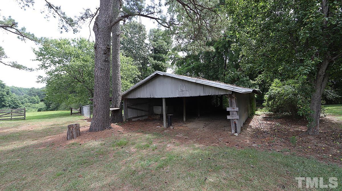 1390 Sanders Road Benson, NC 27504 - Photo 20 of 22 a view of a house with a yard and tree
