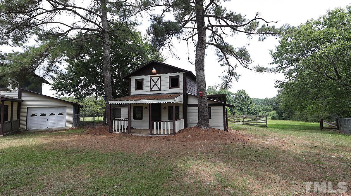 1390 Sanders Road Benson, NC 27504 - Photo 21 of 22 a view of house with a yard