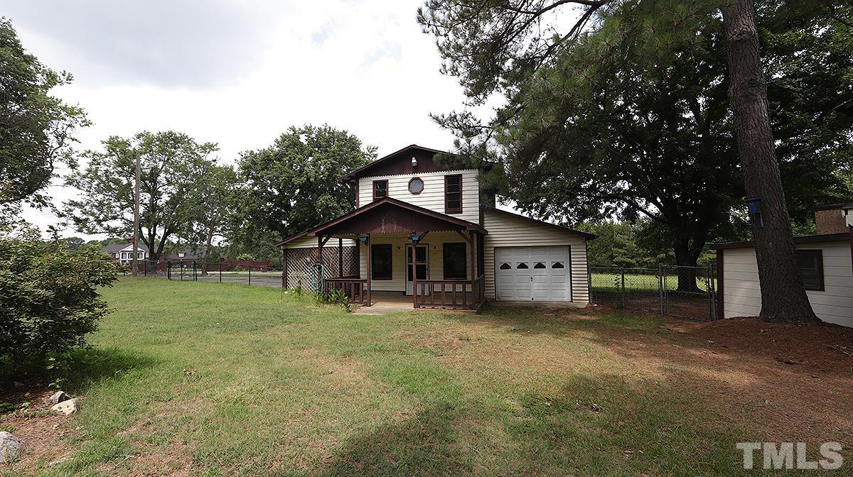 1390 Sanders Road Benson, NC 27504 - Photo 22 of 22 a front view of a house with a yard