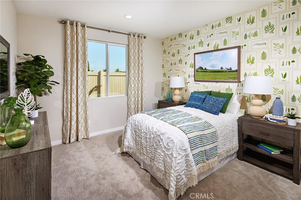 30934 Campania Road Highland, CA 92346 - Photo 12 of 19 a bedroom with a bed and a potted plant