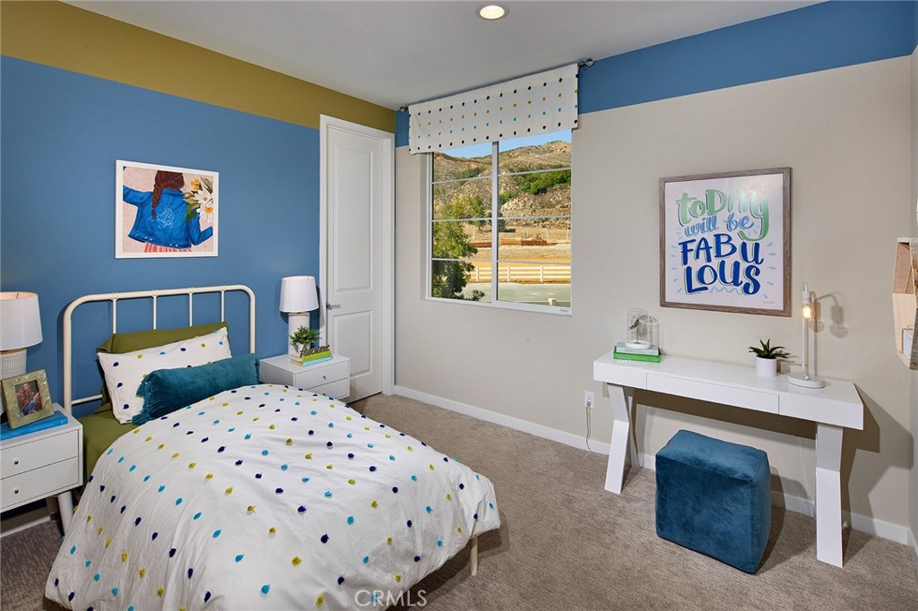 30934 Campania Road Highland, CA 92346 - Photo 14 of 19 a bedroom with a bed and a table in it
