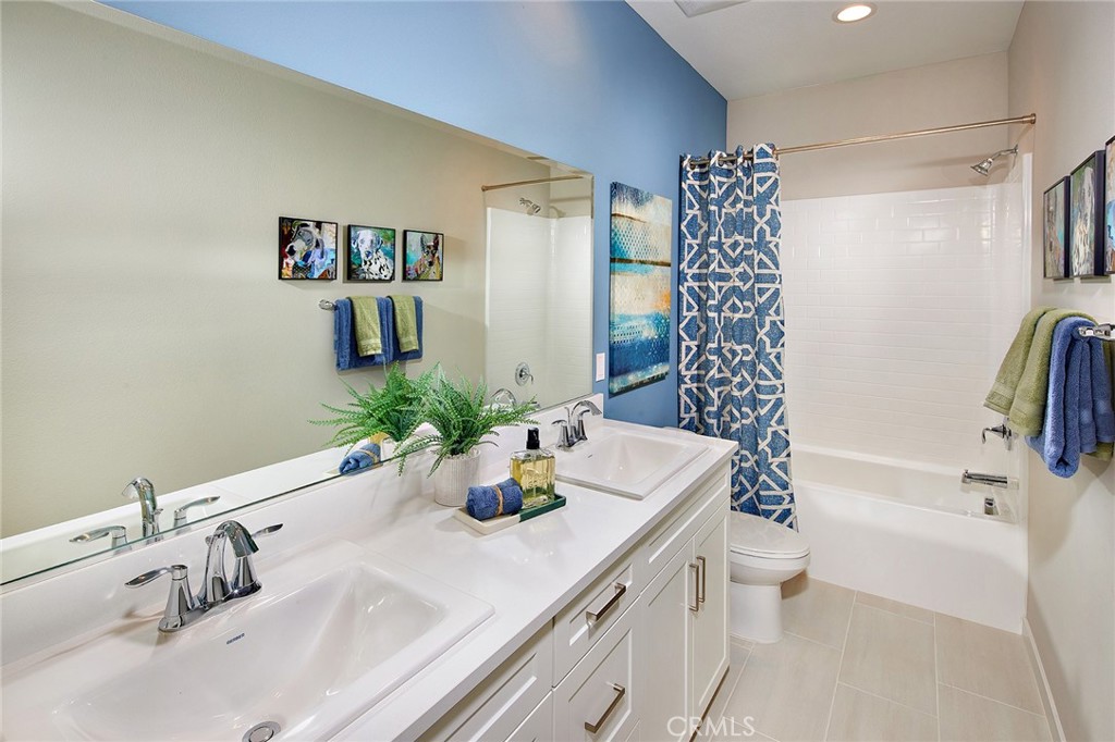 30934 Campania Road Highland, CA 92346 - Photo 16 of 19 a bathroom with a sink a toilet and shower