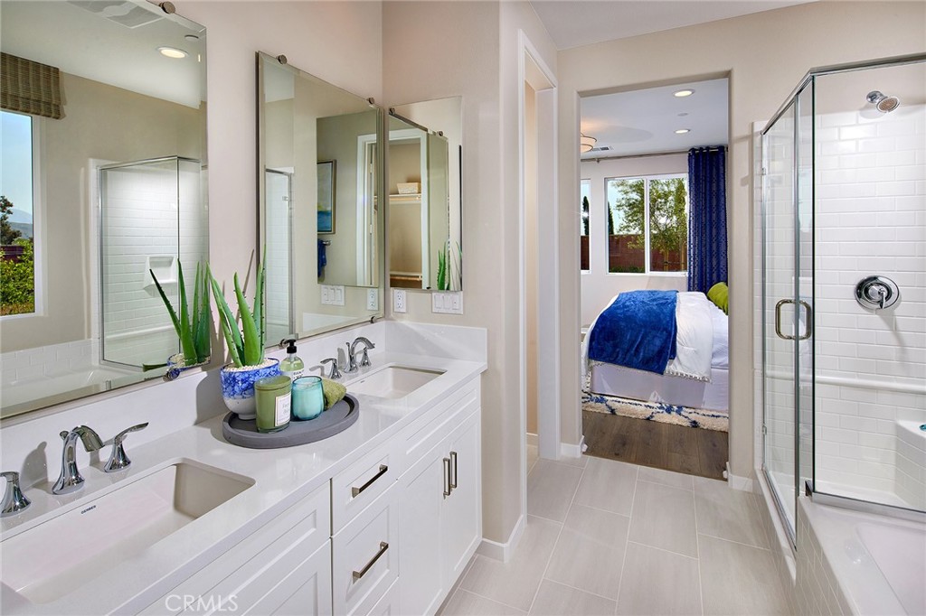30934 Campania Road Highland, CA 92346 - Photo 10 of 19 a bathroom with sink a mirror a potted plant and shower