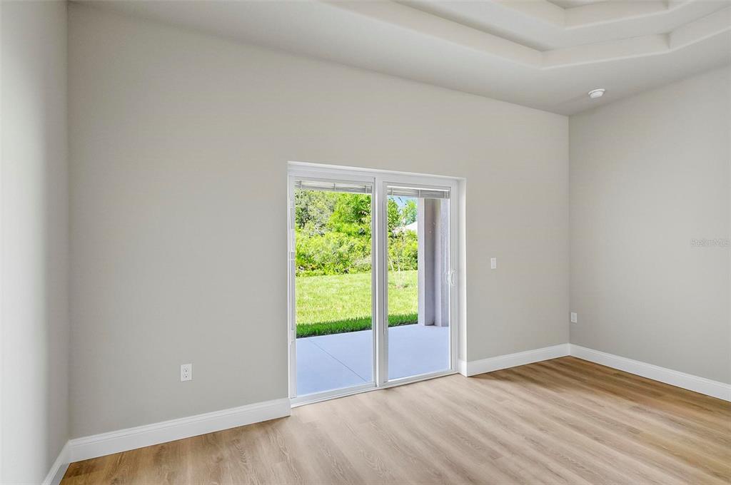 43 Eton Lane, Unit A Palm Coast, FL 32164 - Photo 17 of 78 a view of an empty room with wooden floor and a window