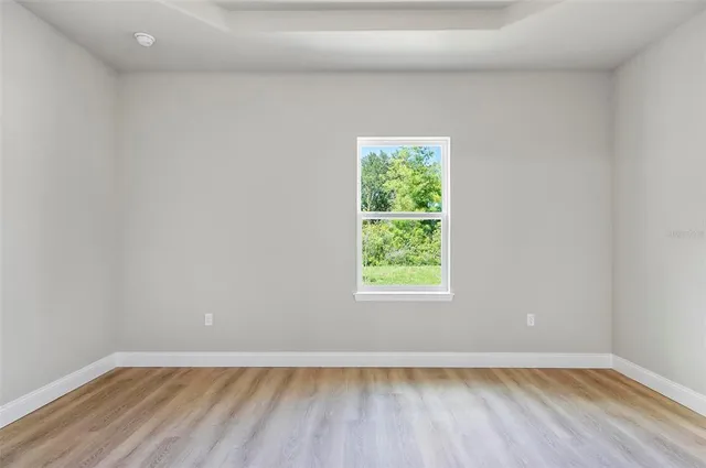 an empty room with wooden floor and closet