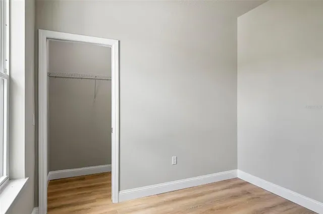 a view of room with wooden floor