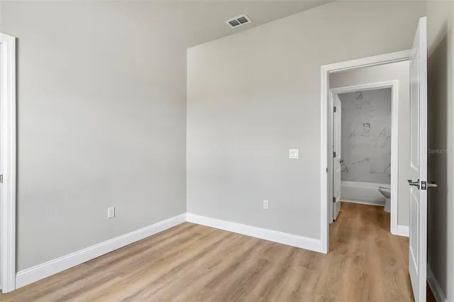 a kitchen with granite countertop white cabinets and a sink