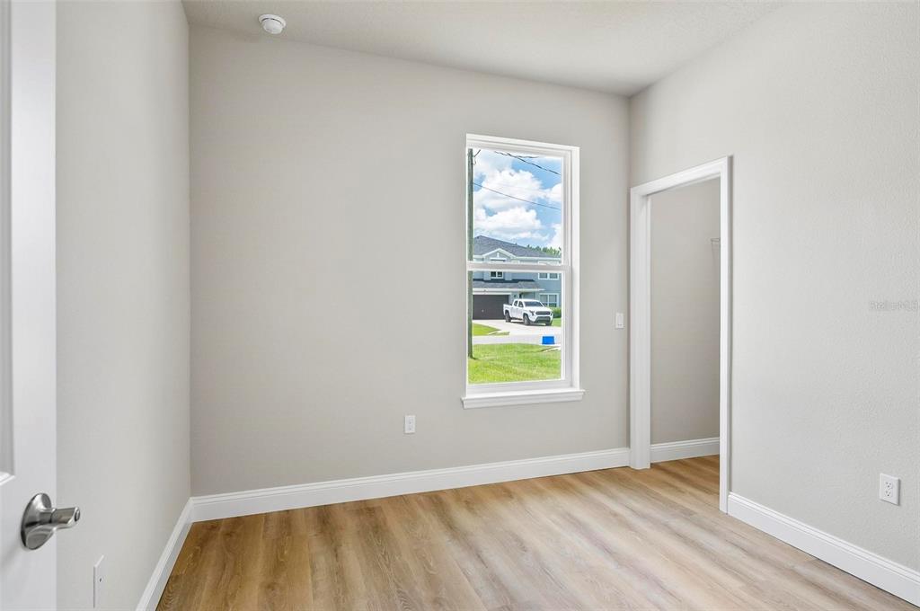 43 Eton Lane, Unit A Palm Coast, FL 32164 - Photo 41 of 78 a view of an empty room and window and wooden floor