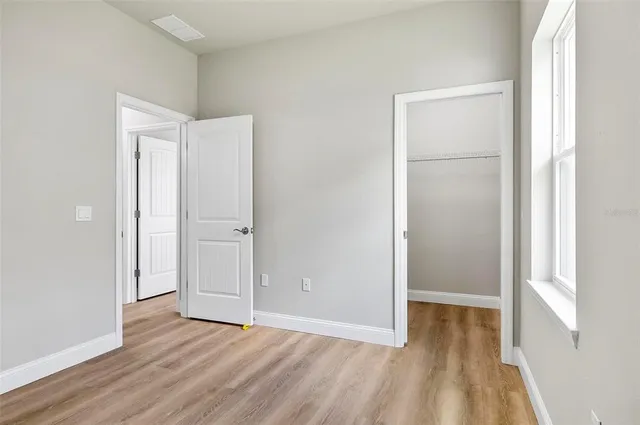 a kitchen with kitchen island a sink cabinets and stainless steel appliances
