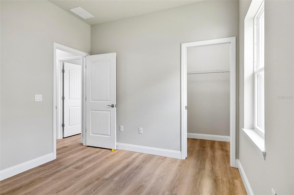 43 Eton Lane, Unit A Palm Coast, FL 32164 - Photo 42 of 78 an empty room with wooden floor and closet